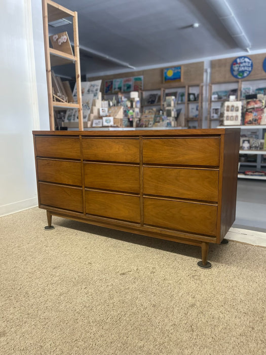 Mid-Century Modern Likely Walnut Nine-Drawer Dresser with Sculpted Pulls, Dovetail Drawers, and Tapered Legs