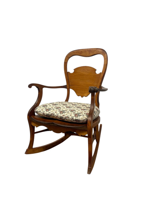Likely Antique Victorian Style Solid Wood Rocking Chair with Carved Arms and Floral Cushion