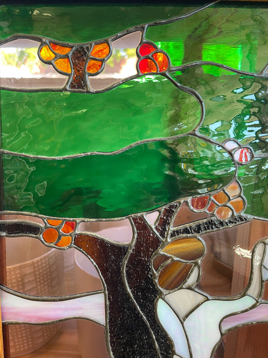 Vintage Stained Glass Art Panel Depicting Woman in Flowing White Dress Beneath Tree with Fruit, Framed in Wooden Oak Toned Frame