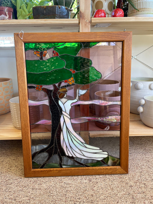 Vintage Stained Glass Art Panel Depicting Woman in Flowing White Dress Beneath Tree with Fruit, Framed in Wooden Oak Toned Frame
