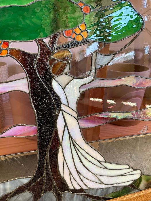 Vintage Stained Glass Art Panel Depicting Woman in Flowing White Dress Beneath Tree with Fruit, Framed in Wooden Oak Toned Frame