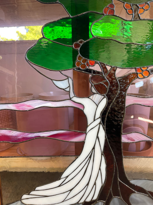 Vintage Stained Glass Art Panel Depicting Woman in Flowing White Dress Beneath Tree with Fruit, Framed in Wooden Oak Toned Frame