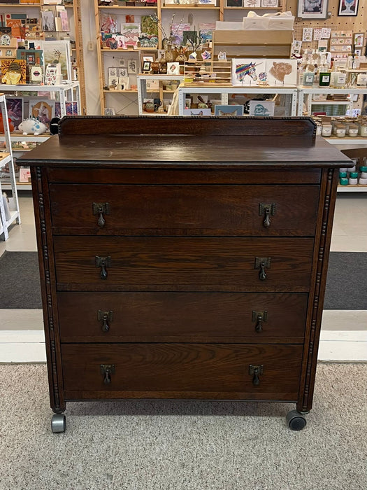 Vintage Four Drawer Dresser on Casters With Carved Wood Detailing.