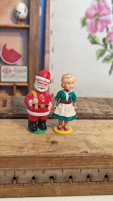 Vintage Mommy kissing Santa plastic figures with Box.