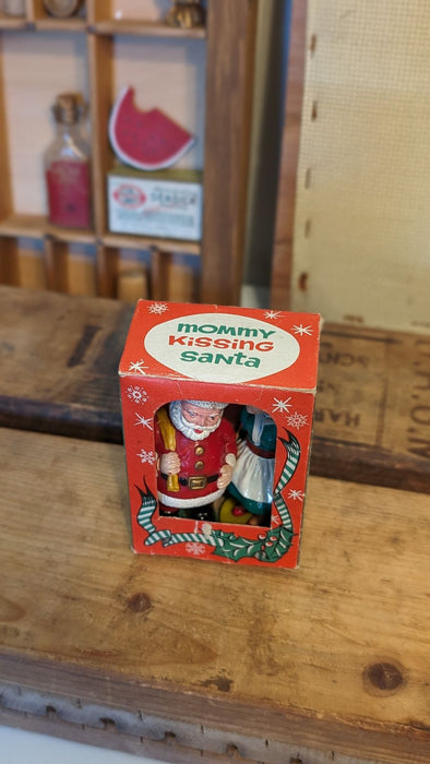 Vintage Mommy kissing Santa plastic figures with Box.