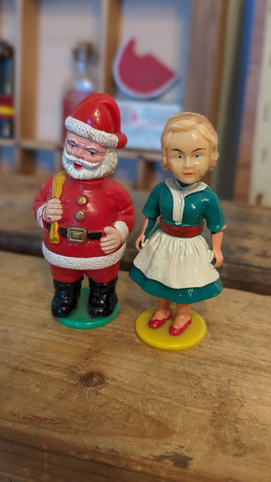 Vintage Mommy kissing Santa plastic figures with Box.