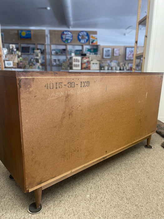 Mid-Century Modern Likely Walnut Nine-Drawer Dresser with Sculpted Pulls, Dovetail Drawers, and Tapered Legs