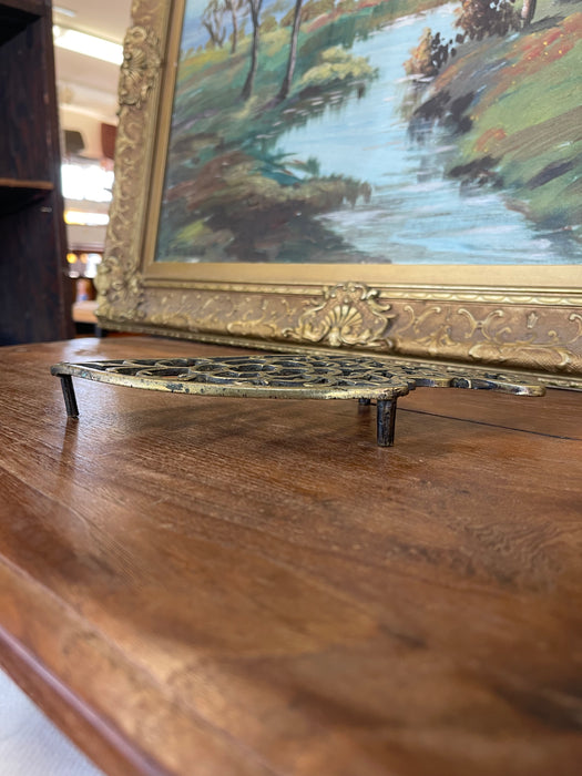 Brass Toned Cast Trivet with Ornate Victorian Design.