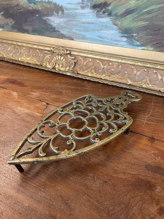 Brass Toned Cast Trivet with Ornate Victorian Design.