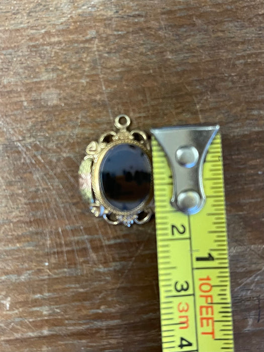 Vintage Gold-Tone Miniature Landscape-Like Pendant with Ornate Filigree
Frame.