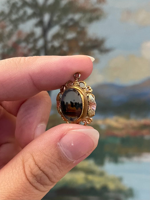 Vintage Gold-Tone Miniature Landscape-Like Pendant with Ornate Filigree
Frame.