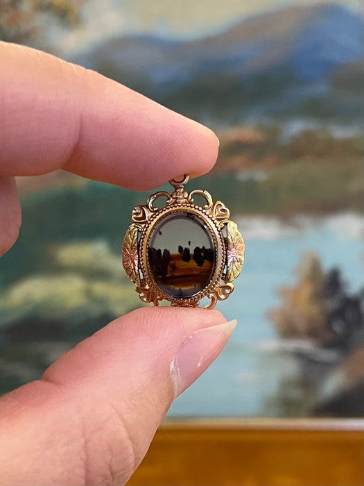 Vintage Gold-Tone Miniature Landscape-Like Pendant with Ornate Filigree
Frame.