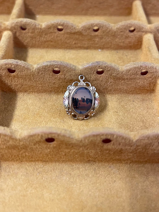 Vintage Gold-Tone Miniature Landscape-Like Pendant with Ornate Filigree
Frame.