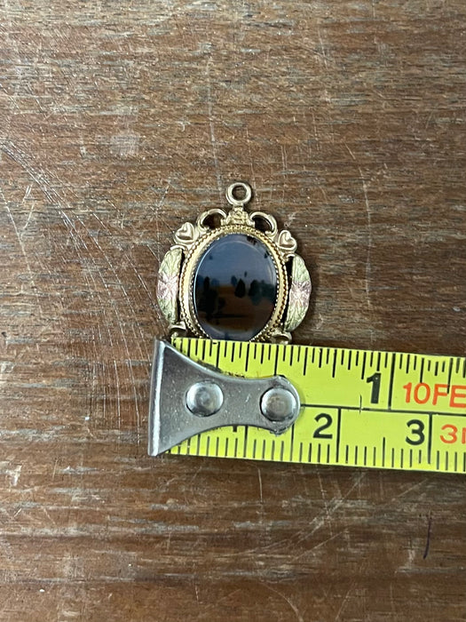 Vintage Gold-Tone Miniature Landscape-Like Pendant with Ornate Filigree
Frame.