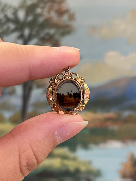 Vintage Gold-Tone Miniature Landscape-Like Pendant with Ornate Filigree
Frame.