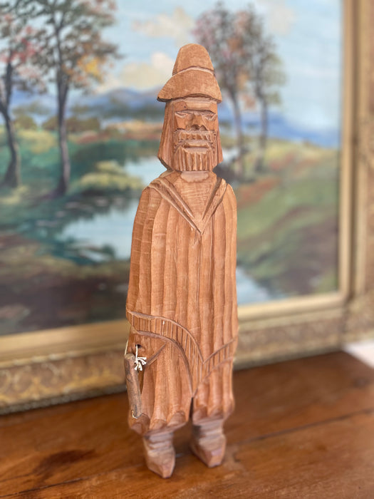 Hand-Carved Vintage Folk Art Wood Figure of Bearded Man with Hat and Carrying a Carved Object.