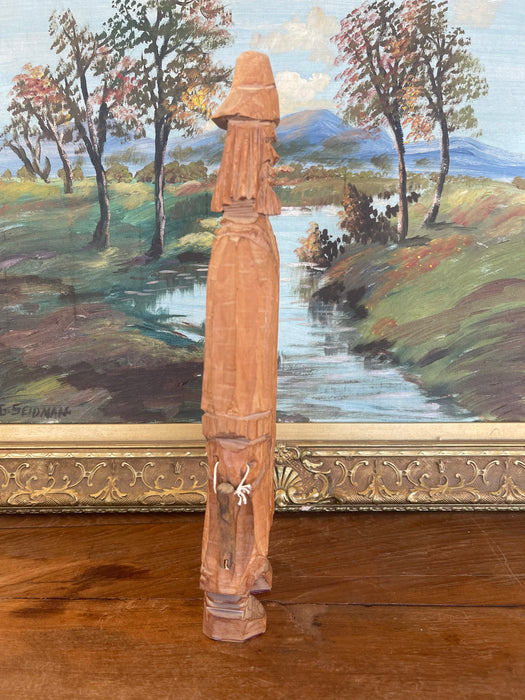 Hand-Carved Vintage Folk Art Wood Figure of Bearded Man with Hat and Carrying a Carved Object.