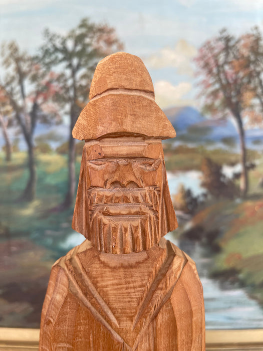 Hand-Carved Vintage Folk Art Wood Figure of Bearded Man with Hat and Carrying a Carved Object.