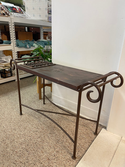 Vintage Hand-Carved Wood and Wrought Iron Console Table with Tribal Motifs and Scrollwork Arms