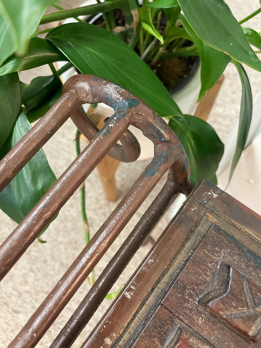 Vintage Hand-Carved Wood and Wrought Iron Console Table with Tribal Motifs and Scrollwork Arms