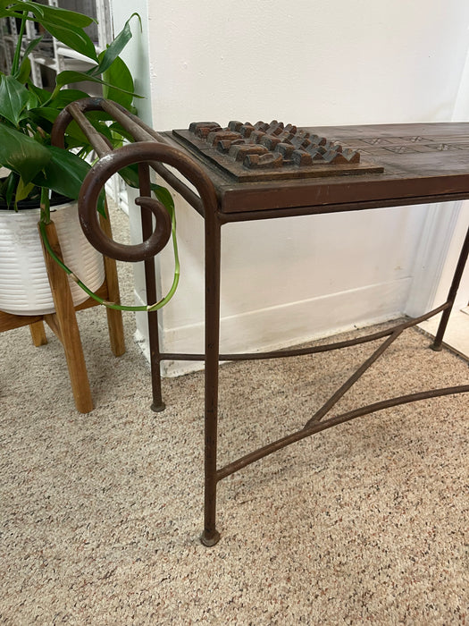 Vintage Hand-Carved Wood and Wrought Iron Console Table with Tribal Motifs and Scrollwork Arms