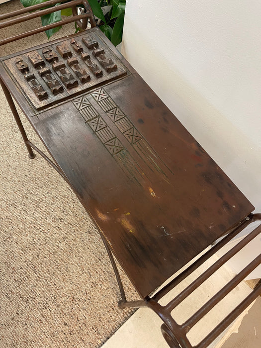 Vintage Hand-Carved Wood and Wrought Iron Console Table with Tribal Motifs and Scrollwork Arms