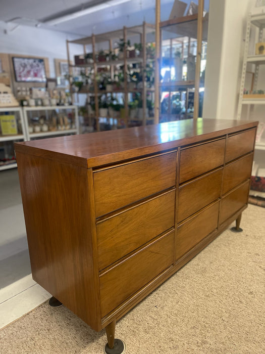 Mid-Century Modern Likely Walnut Nine-Drawer Dresser with Sculpted Pulls, Dovetail Drawers, and Tapered Legs