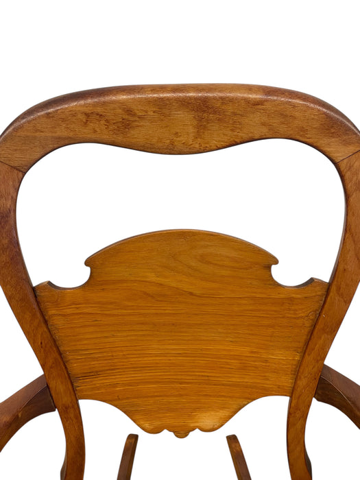 Likely Antique Victorian Style Solid Wood Rocking Chair with Carved Arms and Floral Cushion