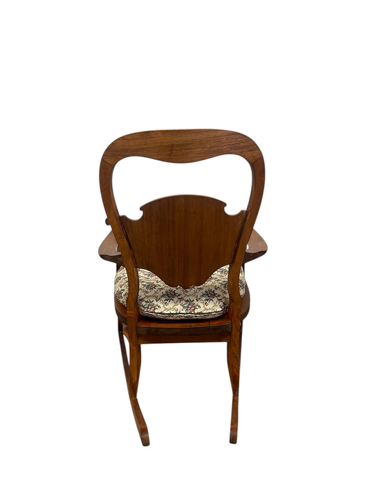 Likely Antique Victorian Style Solid Wood Rocking Chair with Carved Arms and Floral Cushion