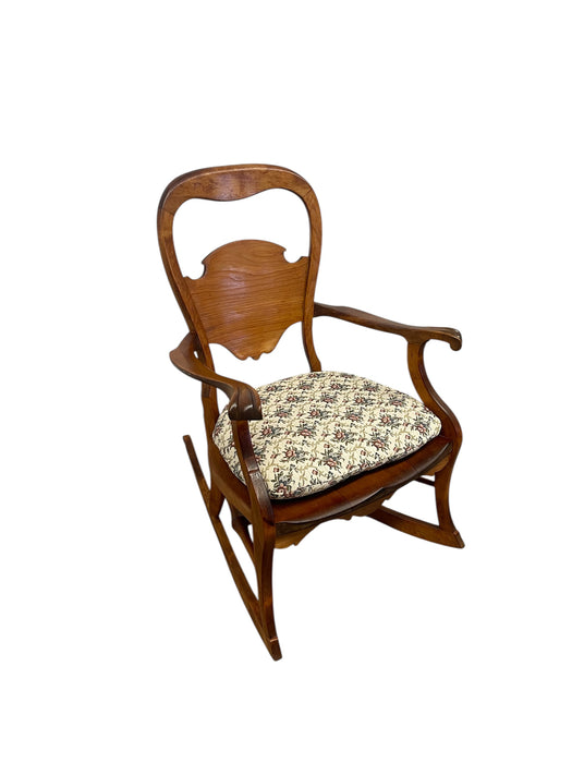 Likely Antique Victorian Style Solid Wood Rocking Chair with Carved Arms and Floral Cushion
