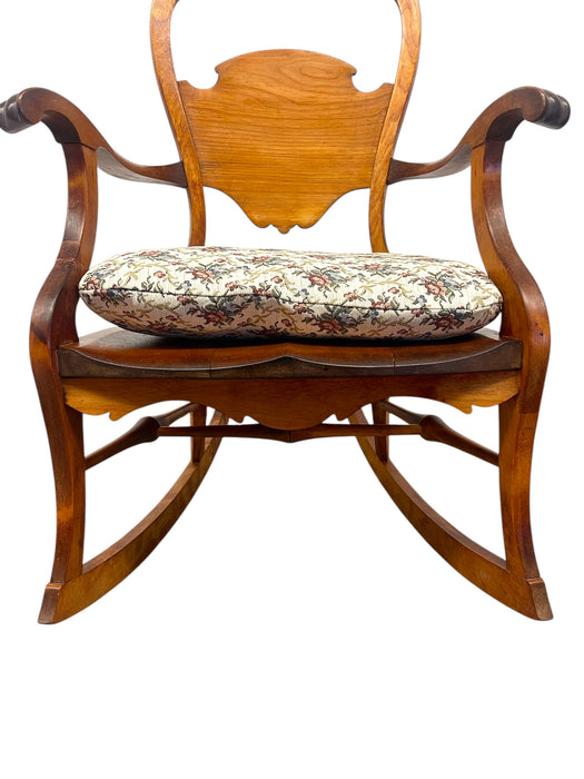 Likely Antique Victorian Style Solid Wood Rocking Chair with Carved Arms and Floral Cushion