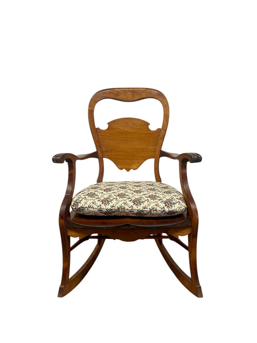 Likely Antique Victorian Style Solid Wood Rocking Chair with Carved Arms and Floral Cushion