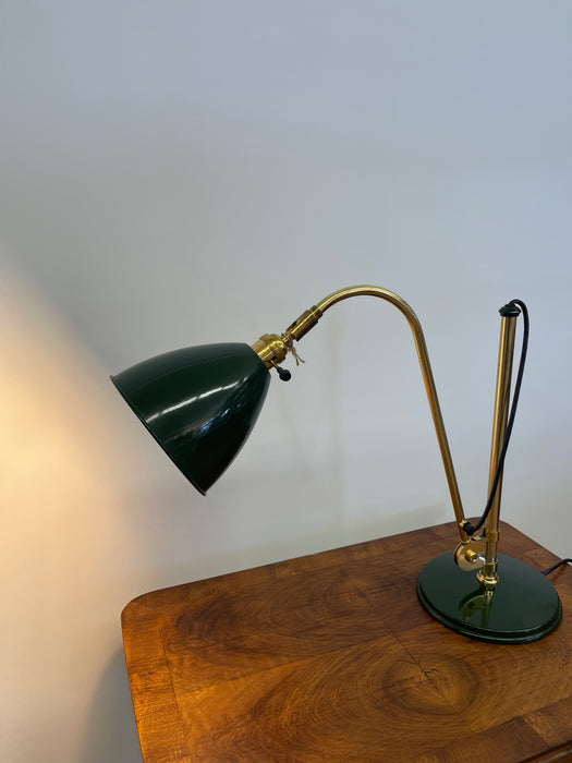 Vintage Adjustable Green and Brass Toned Desk Lamp with Articulated Arm and weighted base.