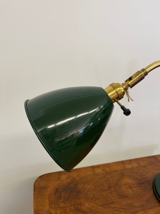 Vintage Adjustable Green and Brass Toned Desk Lamp with Articulated Arm and weighted base.
