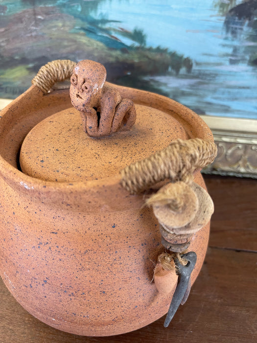 Handmade Indonesian Terracotta Lidded Jar with Beaded Raffia Accents and Seated Figure Finial