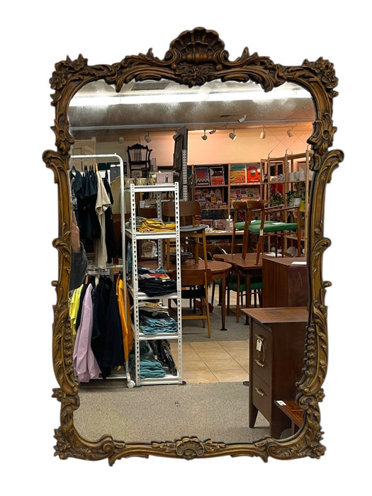 French Louis XV Style Carved Giltwood Wall Mirror with Shell Crest and Floral Details