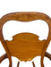 Likely Antique Victorian Style Solid Wood Rocking Chair with Carved Arms and Floral Cushion