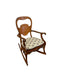 Likely Antique Victorian Style Solid Wood Rocking Chair with Carved Arms and Floral Cushion