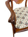 Likely Antique Victorian Style Solid Wood Rocking Chair with Carved Arms and Floral Cushion