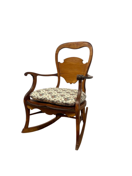 Likely Antique Victorian Style Solid Wood Rocking Chair with Carved Arms and Floral Cushion