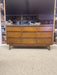 Mid-Century Modern Likely Walnut Nine-Drawer Dresser with Sculpted Pulls, Dovetail Drawers, and Tapered Legs