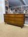 Mid-Century Modern Likely Walnut Nine-Drawer Dresser with Sculpted Pulls, Dovetail Drawers, and Tapered Legs