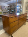 Mid-Century Modern Likely Walnut Nine-Drawer Dresser with Sculpted Pulls, Dovetail Drawers, and Tapered Legs
