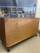 Mid-Century Modern Likely Walnut Nine-Drawer Dresser with Sculpted Pulls, Dovetail Drawers, and Tapered Legs