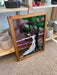 Vintage Stained Glass Art Panel Depicting Woman in Flowing White Dress Beneath Tree with Fruit, Framed in Wooden Oak Toned Frame