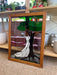 Vintage Stained Glass Art Panel Depicting Woman in Flowing White Dress Beneath Tree with Fruit, Framed in Wooden Oak Toned Frame